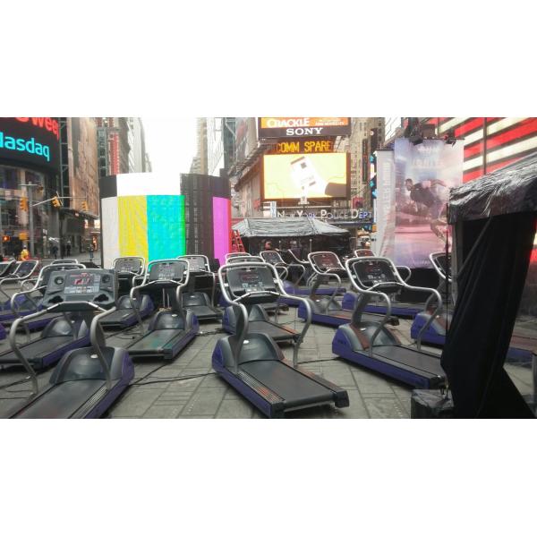 A row of treadmills on a street in Times Square, featuring both new and remanufactured gym equipment. A row of treadmills on a street in Times Square, featuring both new and remanufactured gym equipment.