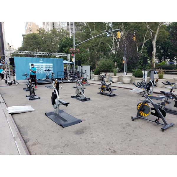 A group of remanufactured stationary bikes on a city street.