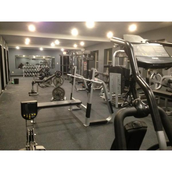 A gym with a lot of New & Remanufactured Gym Equipment in it.