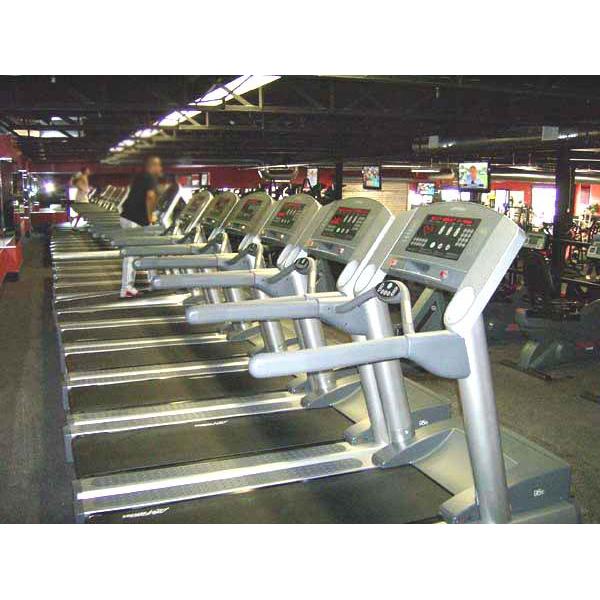 A row of new tread machines in a gym. A row of new tread machines in a gym.