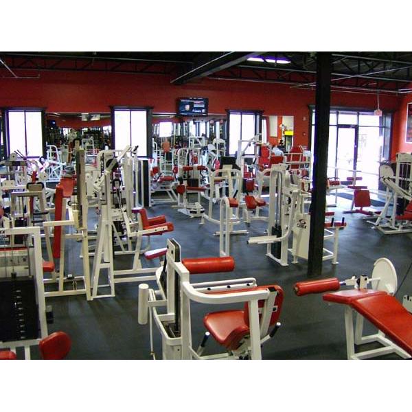 A large gym with a variety of new and remanufactured red and white equipment. A large gym with a variety of new and remanufactured red and white equipment.