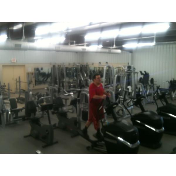 A man using a remanufactured exercise machine. A man using a remanufactured exercise machine.