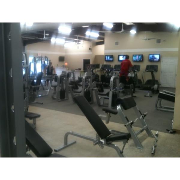 A gym with a lot of new and remanufactured equipment and TVs. A gym with a lot of new and remanufactured equipment and TVs.
