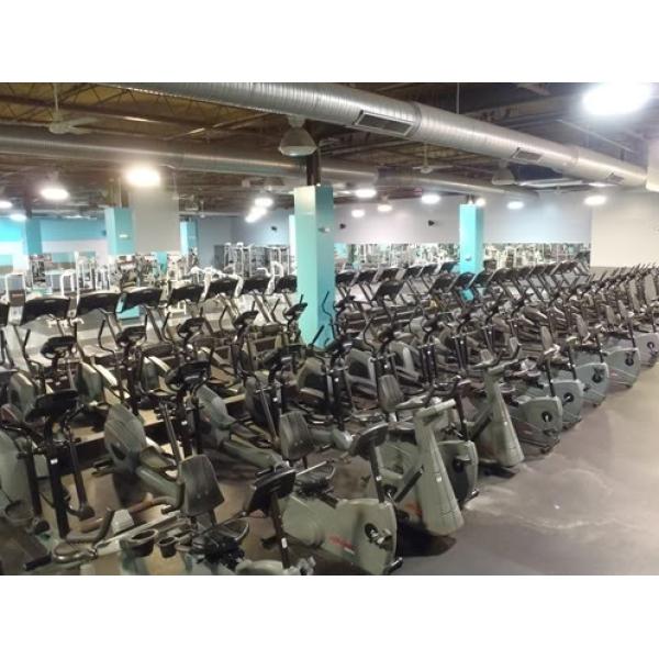 A spacious room filled with a variety of new stationary bikes and remanufactured gym equipment. A spacious room filled with a variety of new stationary bikes and remanufactured gym equipment.