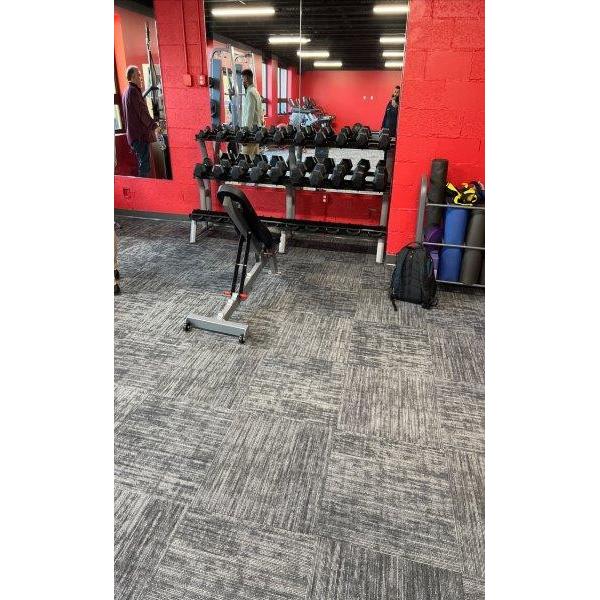 A gym with new weights and a red wall, equipped with remanufactured gym equipment. A gym with new weights and a red wall, equipped with remanufactured gym equipment.