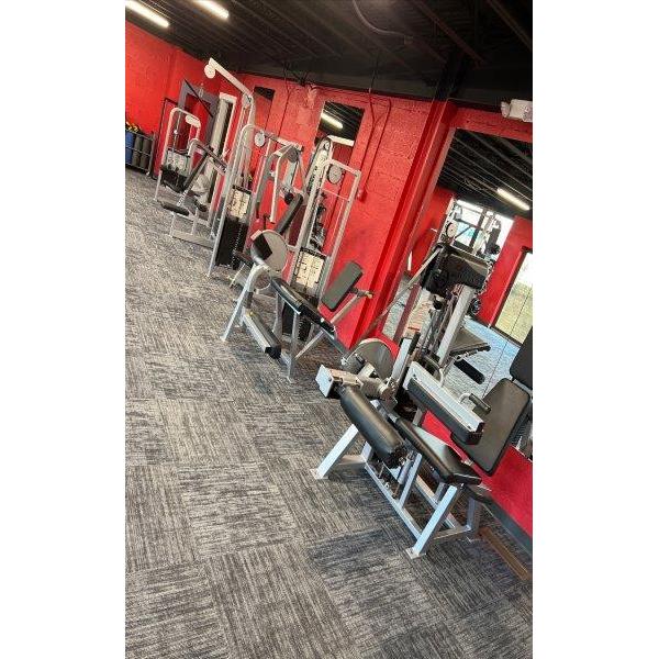 A gym with a lot of new and remanufactured equipment and red walls. A gym with a lot of new and remanufactured equipment and red walls.