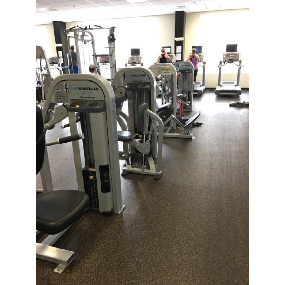 A collection of both new and remanufactured exercise equipment in a gym.