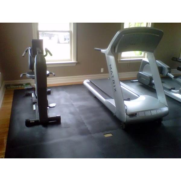 A gym with New & Remanufactured Gym Equipment including treadmills and exercise equipment.