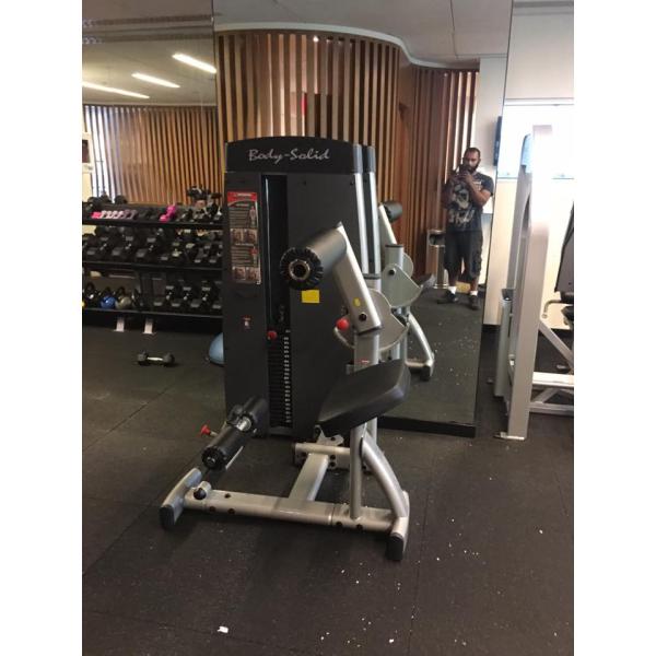 A person standing in front of a new gym machine at the gym. A person standing in front of a new gym machine at the gym.
