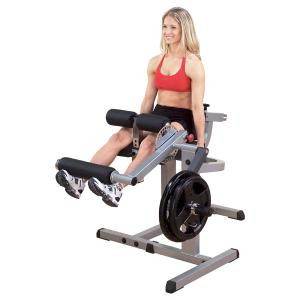 A woman is sitting on a Body Solid Cam Series Plate Loaded Leg Curl & Extension Machine - New.