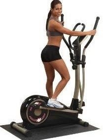 A woman on a Body Solid Cross Trainer Elliptical - New.