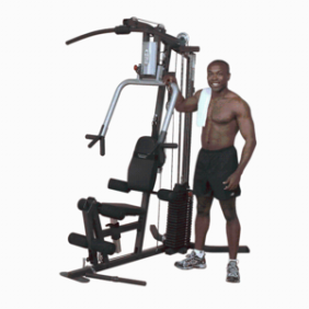 A man standing next to a Body-Solid G3S Selectorized Home Gym - New.