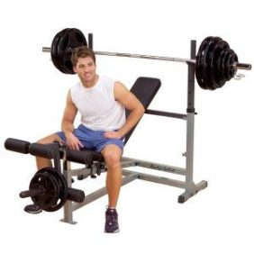 A man sitting on a bench with the Body Solid Powercenter Combo Bench - New.