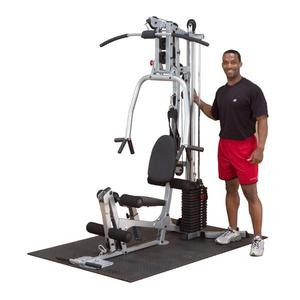 A man standing in front of a Body Solid Powerline Home Gym - New.