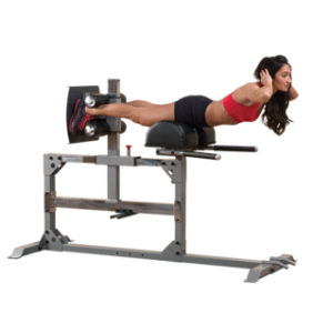 A woman engaged in a sit-up exercise on the Body Solid Pro Clubline Hyperextension - New machine.