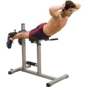 A man exercising on a Body Solid Roman Chair - New, performing a sit-up.