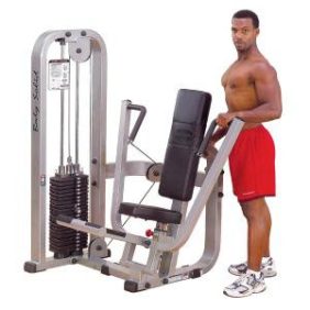 A man standing in front of a new Body Solid Selectorized Pro Clubline Chest Press Machine 310 lbs Stack - New.