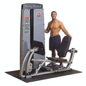 A man standing next to a Body Solid Selectorized Pro Dual Leg Press & Calf Press Machine - New.
