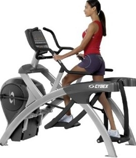 A woman is riding a Cybex 750a Lower Body Arc Trainer - Remanufactured on a white background, showcasing both new and remanufactured gym equipment.