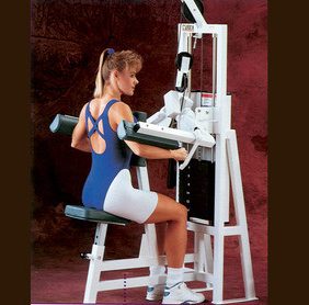 A woman sitting on a Cybex Classic Selectorized Lat Raise - Remanufactured.