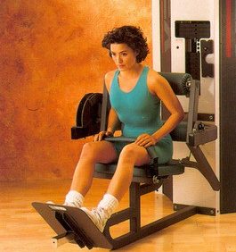 New woman sitting on a Cybex Modular Lower Back- Remanufactured in a gym.