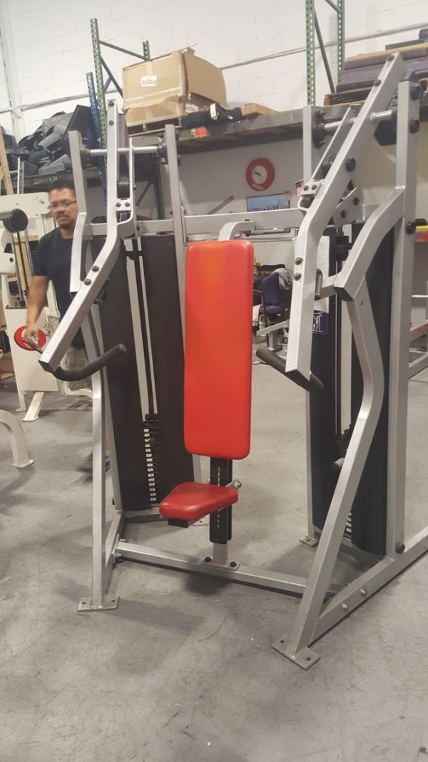 A Hammer Strength MTS Chest (Cleaned & Serviced) gym machine with a new red seat.