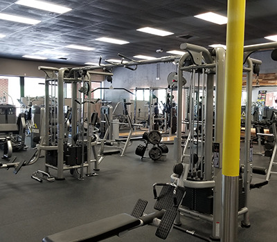 A gym with a lot of new and remanufactured equipment in it.