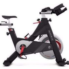A Matrix Indoor Cycle - Serviced with a seat and handlebars, available as new or remanufactured gym equipment.