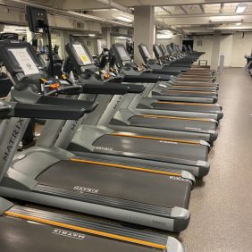 A row of Matrix 7xe Treadmills - Serviced in a gym.