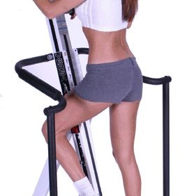 A woman is standing on a VersaClimber ALX - New exercise machine.