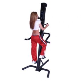 A woman is standing on a **VersaClimber SMA - New** exercise machine.