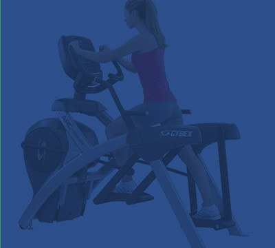 A woman exercising on a new elliptical machine.