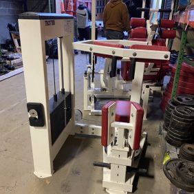 A group of Trotter Galileo Rotary Torso - As Is Functional gym equipment in a warehouse.