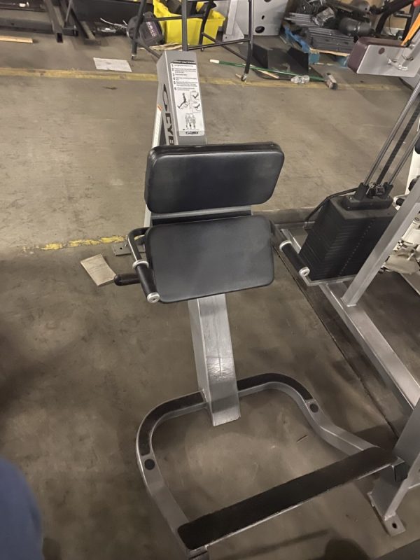 A new gym machine is sitting in a warehouse.