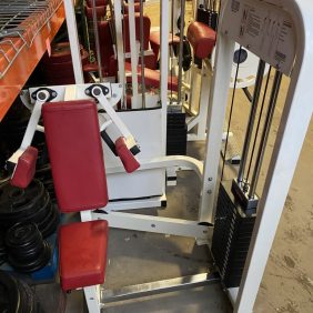 A new red and white gym machine in a warehouse.