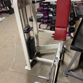 A gym machine, either new or remanufactured, is sitting in a room with other equipment.