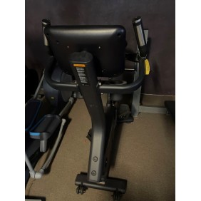 A Pulse Upright Bike - New with a digital display is elegantly positioned against a dark wall on the carpeted floor.