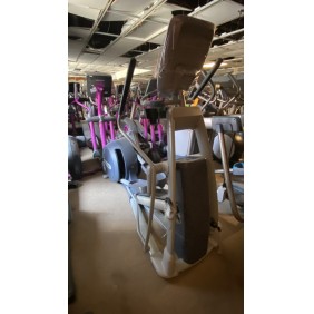 A row of Vision Recumbent - Serviced machines in a dimly lit Fitness Plus gym with high ceilings and exposed ductwork.