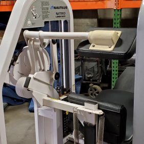In a gym, the Nautilus Nitro Lower Back - As Is Functional machine offers an effective lower back workout experience with weights and comfortable seating.