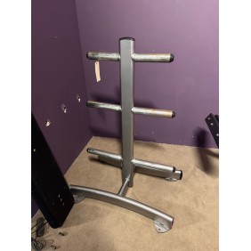 A Body Core Incline Bench in silver stands against a purple wall on a beige carpet, ideal for workouts.