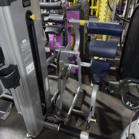 The Icarian Triceps Extension - As Is Functional is a seated gym machine with pads and handles for focused triceps extensions—perfect for arm workouts in functional fitness routines.